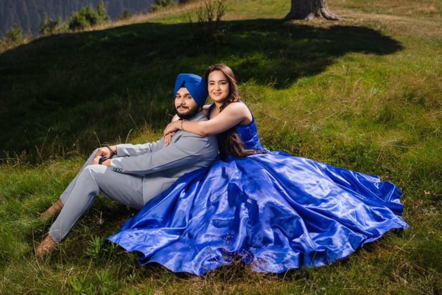Destination pre wedding photoshoot in Kashmir with a couple posing in lush green meadows