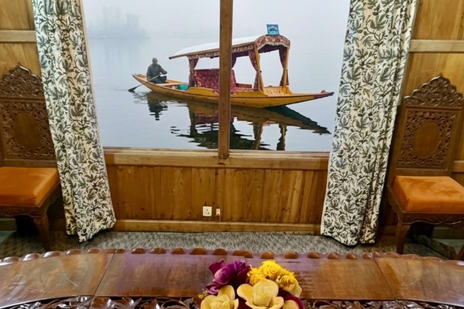Shikara boat view from houseboat in Kashmir room window on Dal Lake Srinagar Kashmir