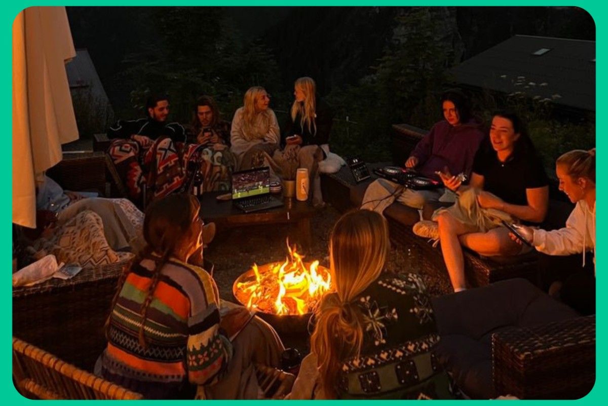 Group enjoying a cozy bonfire evening during a Kashmir tour package in a peaceful mountain stay