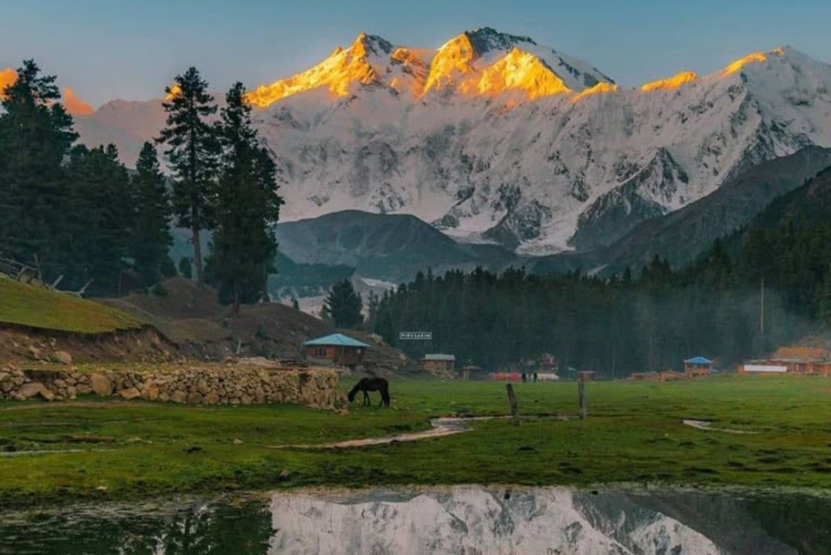 Snow-covered mountains and green valley in Kashmir during summer