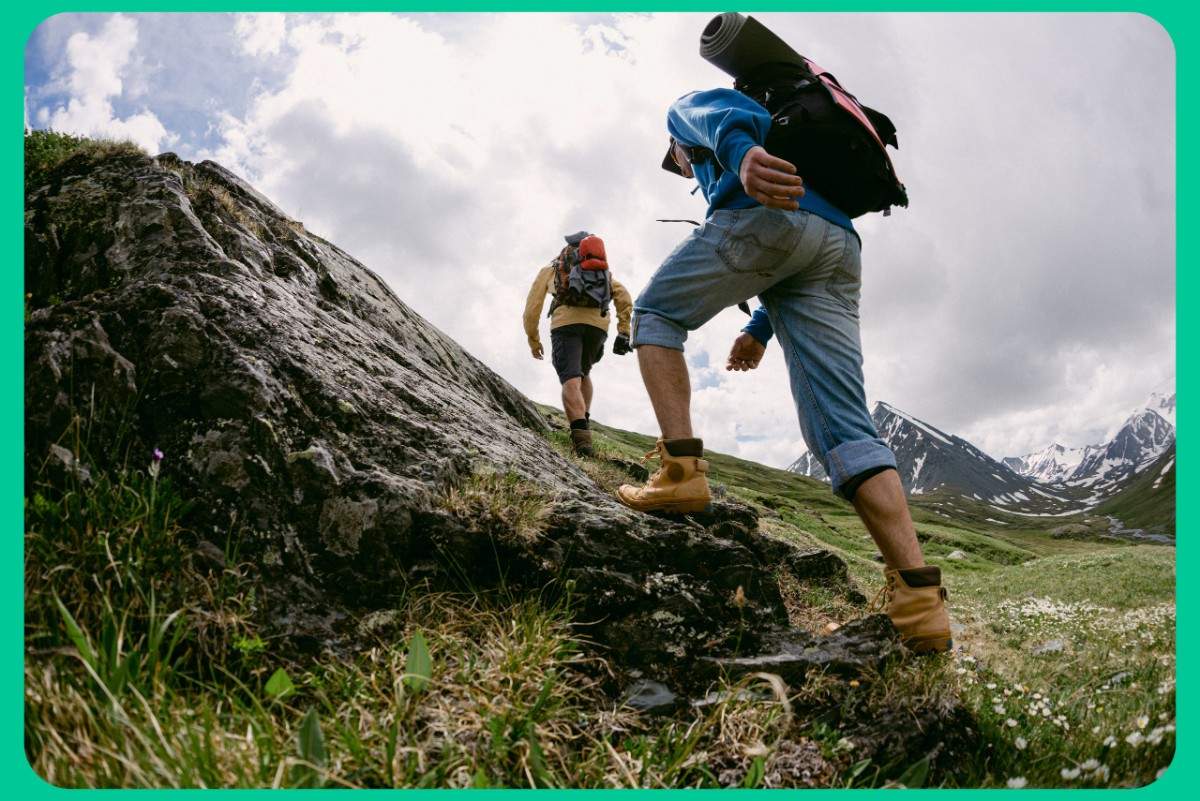 Tourists trekking through scenic mountains on an adventure Kashmir tour package