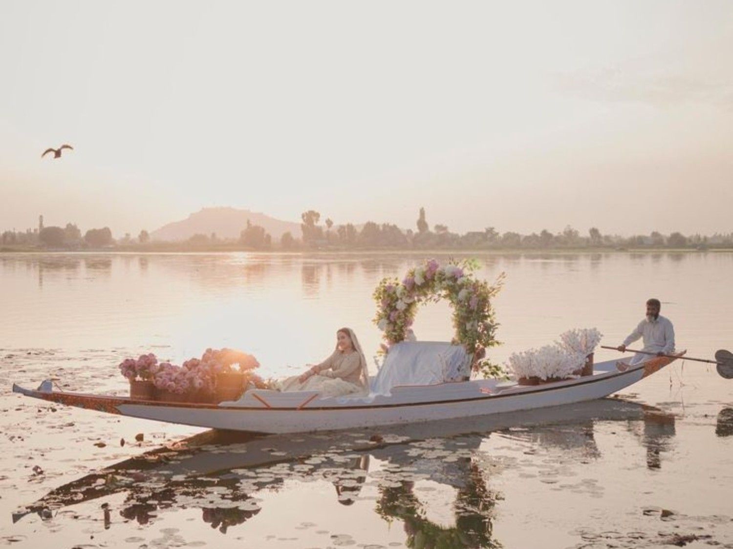 Romantic shikara pre wedding photoshoot on Dal Lake Kashmir during golden hour