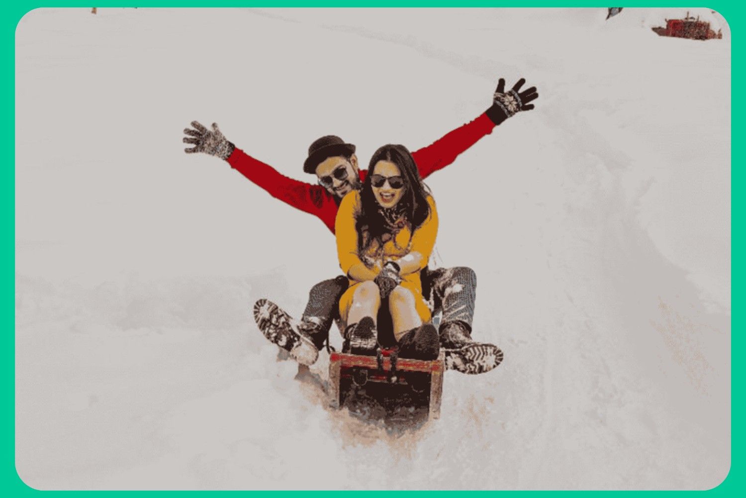 Couple enjoying snowfall in Kashmir during winter tour packages with snow activities