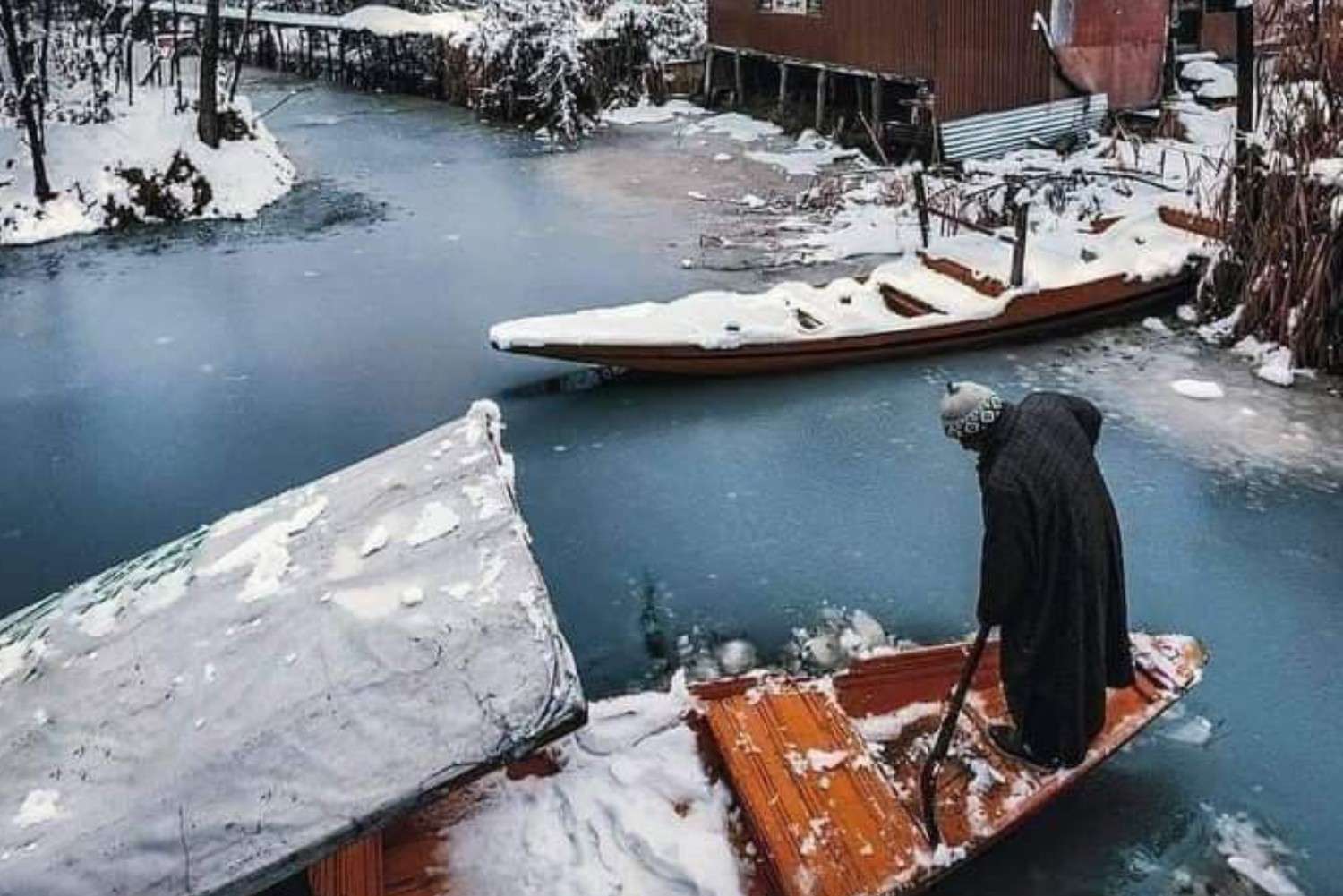 Winter shikara ride on frozen lake in Srinagar Kashmir