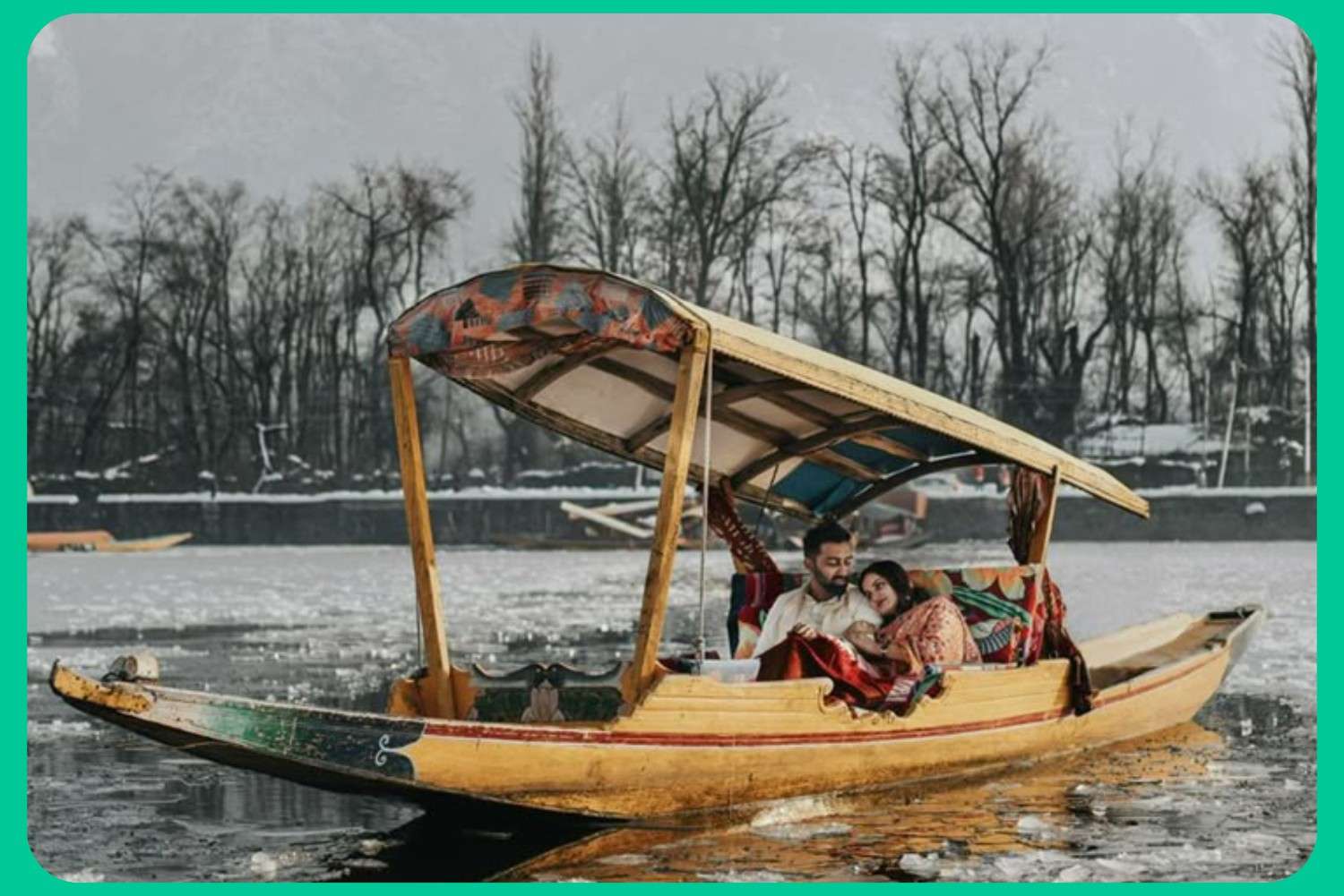 Romantic shikara ride on frozen Dal Lake during winter, ideal for honeymoon kashmir tour packages with houseboat stay