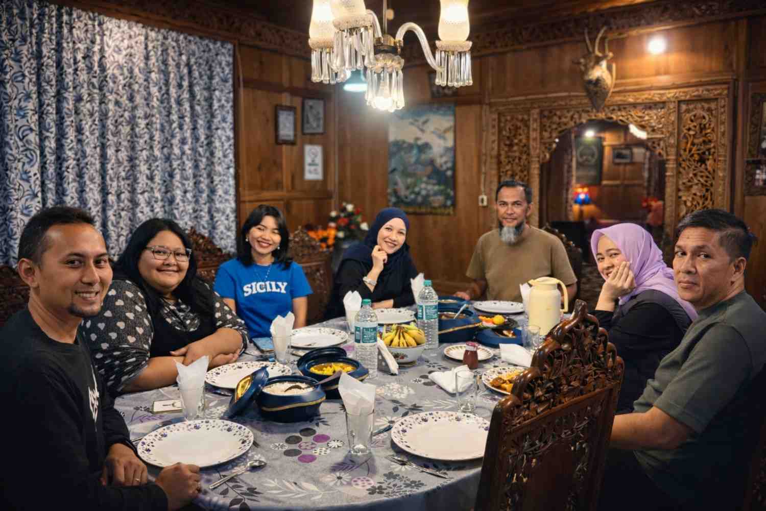 Family dining experience inside luxury Kashmiri houseboat Srinagar