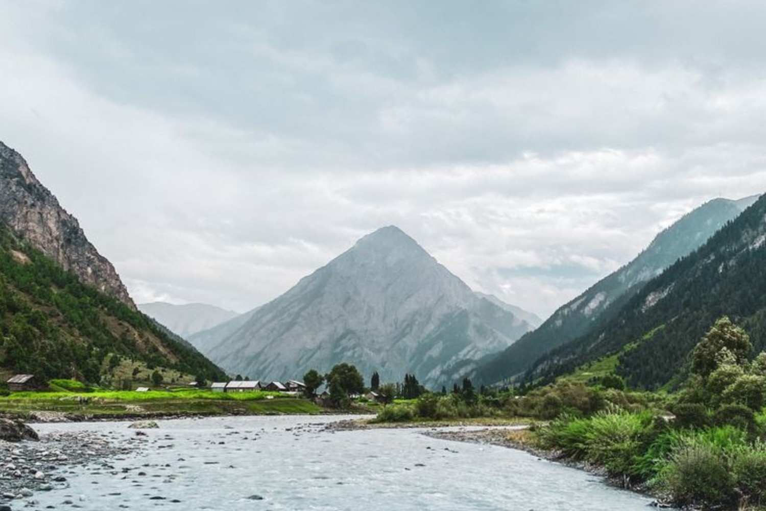Peaceful river landscape in Gurez Valley Kashmir with dramatic Himalayan mountain backdrop